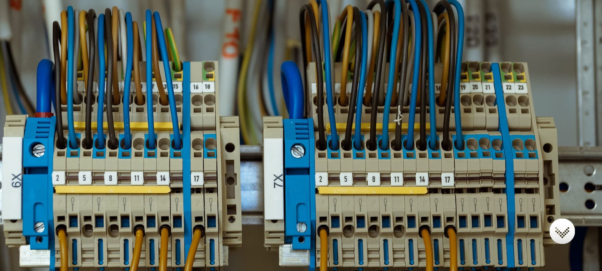 Electrical finger safe fuse boxes with several wires connected and running through.