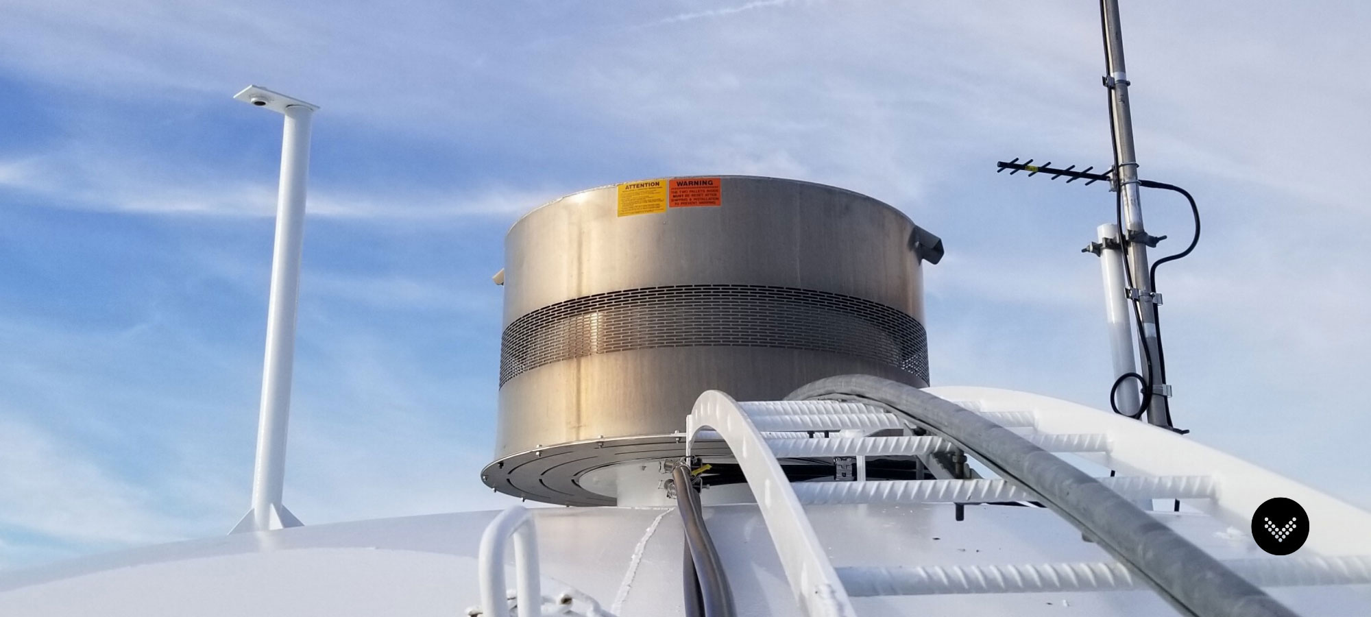 Top side of a water tank featuring the side bowl ladder, top vent, and communications antenna.