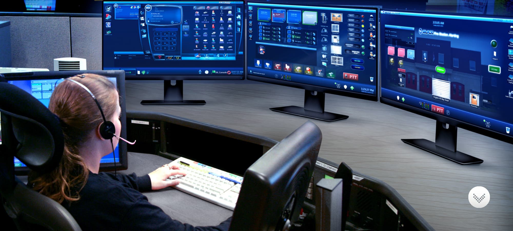 Women sitting at dispatch position in front of several zetron monitors.